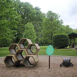 2026_300x300_PlayPod_Bees A play pod learning experience for children depicting "bees" on the trail at Veterans Park